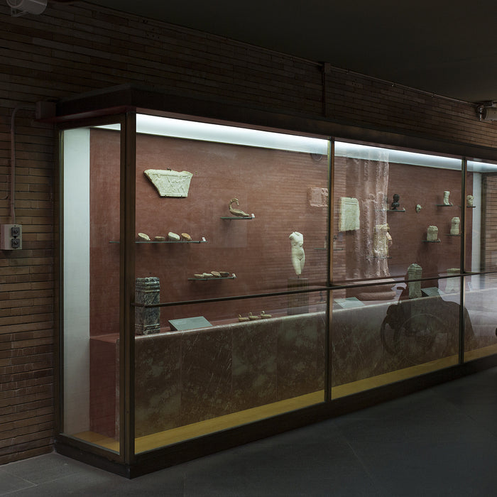 Woman in a wheelchair iobserves glass cabinet at National Museum of Roman Art in Merida, Spain