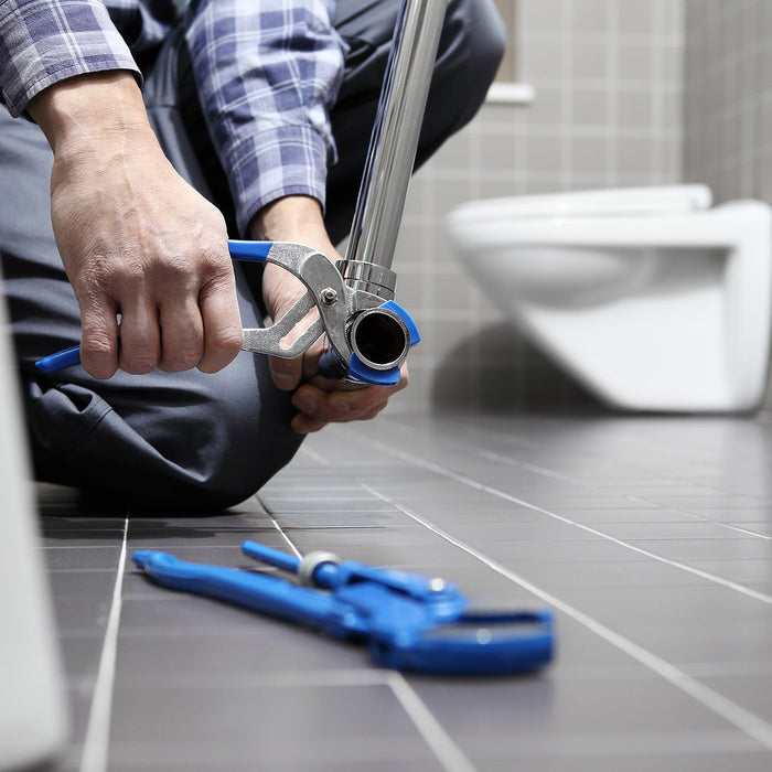 deep U channels - hands plumber at work in a bathroom