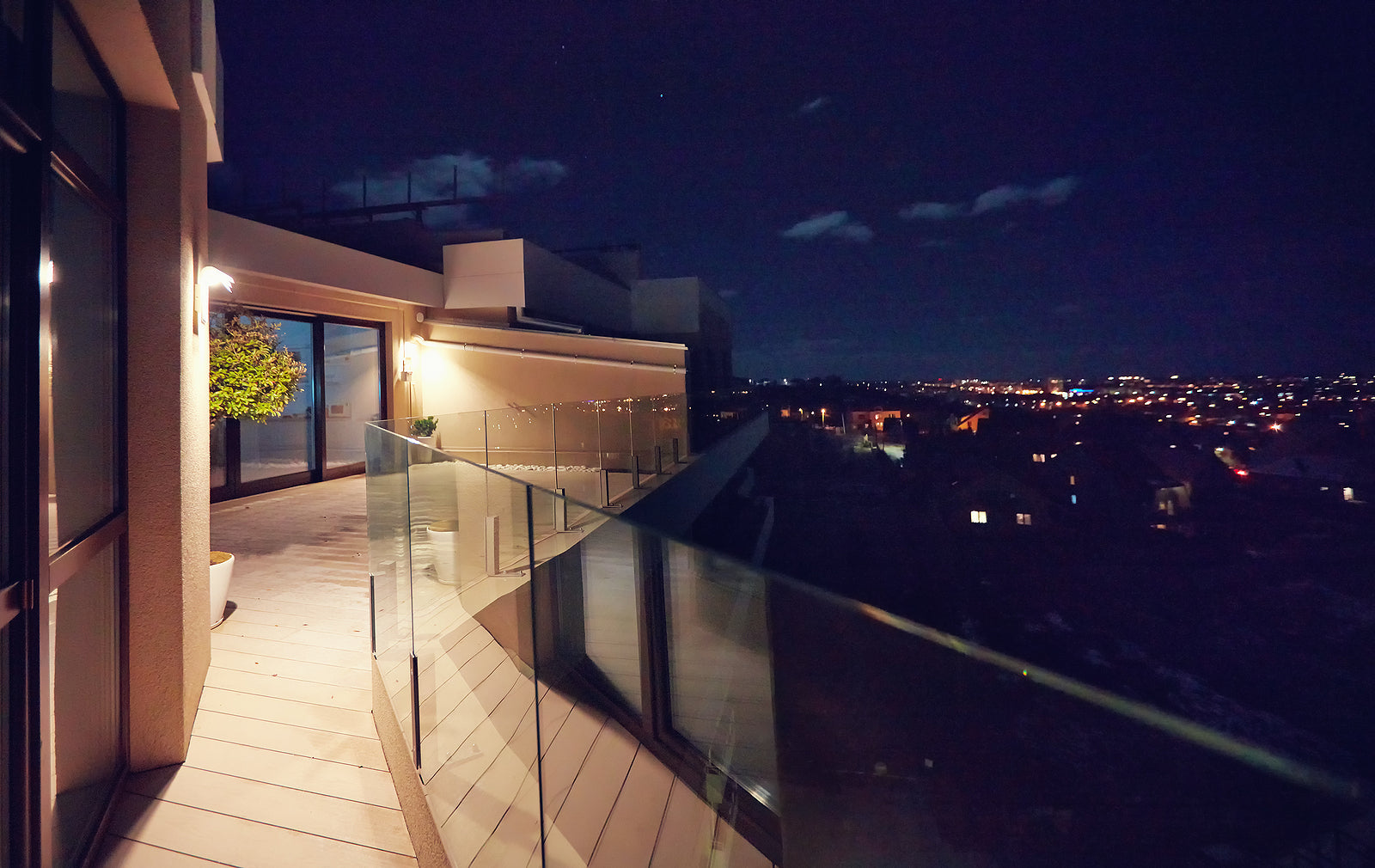 glass balustrade clamps - rooftop patio with glass balustrade