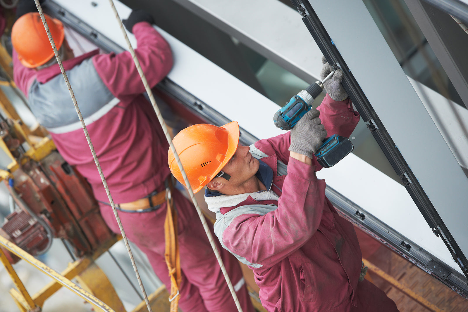 glass hardware - builders worker installing glass windows