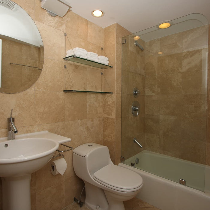  light bulb door knobs - Beautifully designed bathroom with tub and glass.